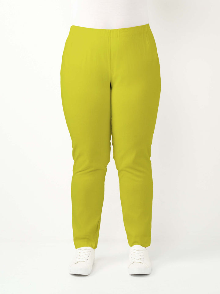 a woman wearing a vibrant lime green bengaline pant in full length straight leg
