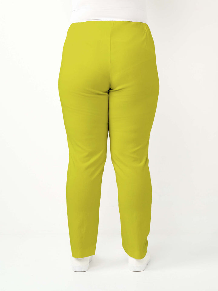 back view of a woman wearing a vibrant lime green bengaline pant in full length straight leg