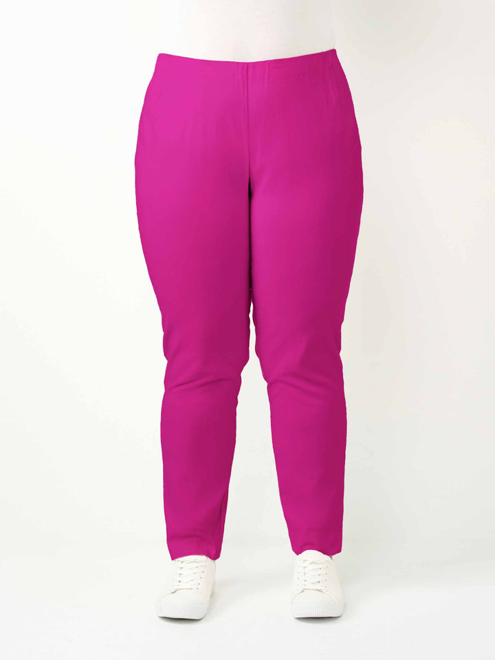 a woman wearing a vibrant hot pink bengaline pant in full length straight leg