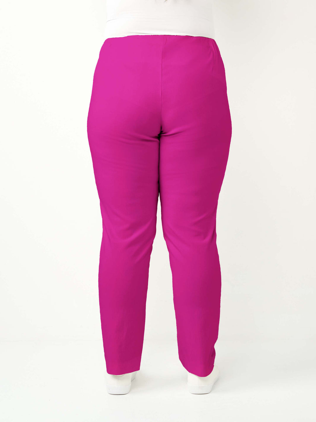 back view of a woman wearing a vibrant hot pink bengaline pant in full length straight leg