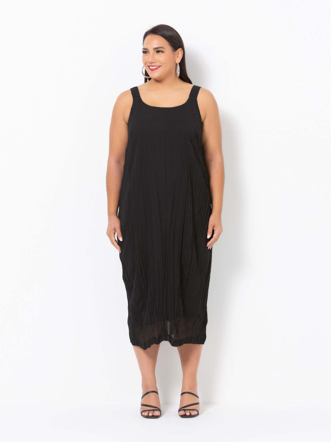 a woman wearing a plain black crushed georgette evening dress