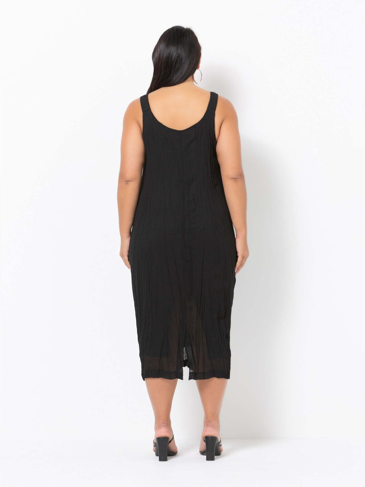 a woman wearing a plain black crushed georgette evening dress