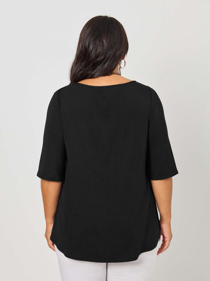 back view of a woman wearing a classic plain black tee top