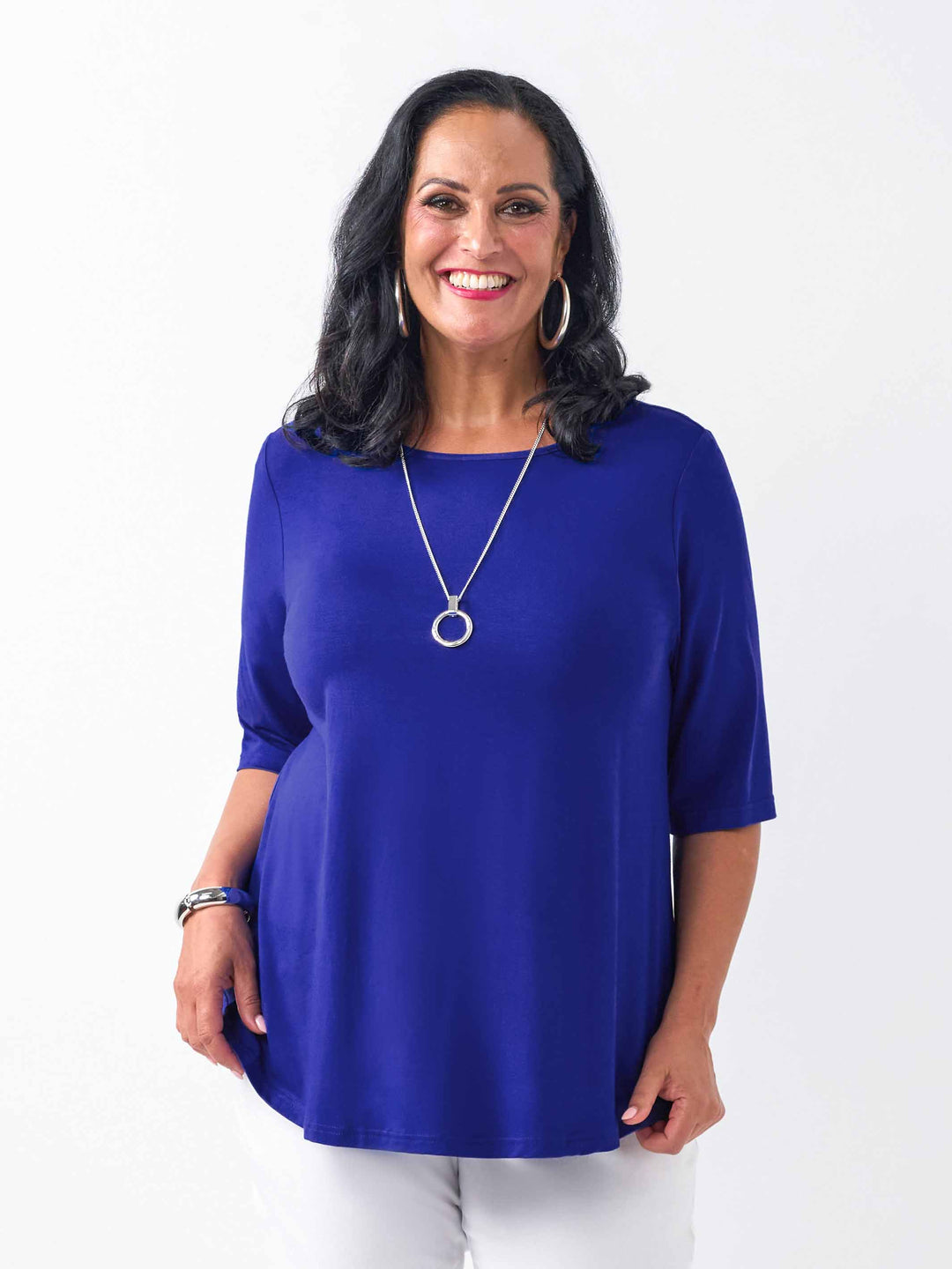 front view of model wearing a bright ocean blue three-quarter sleeve basic T-shirt