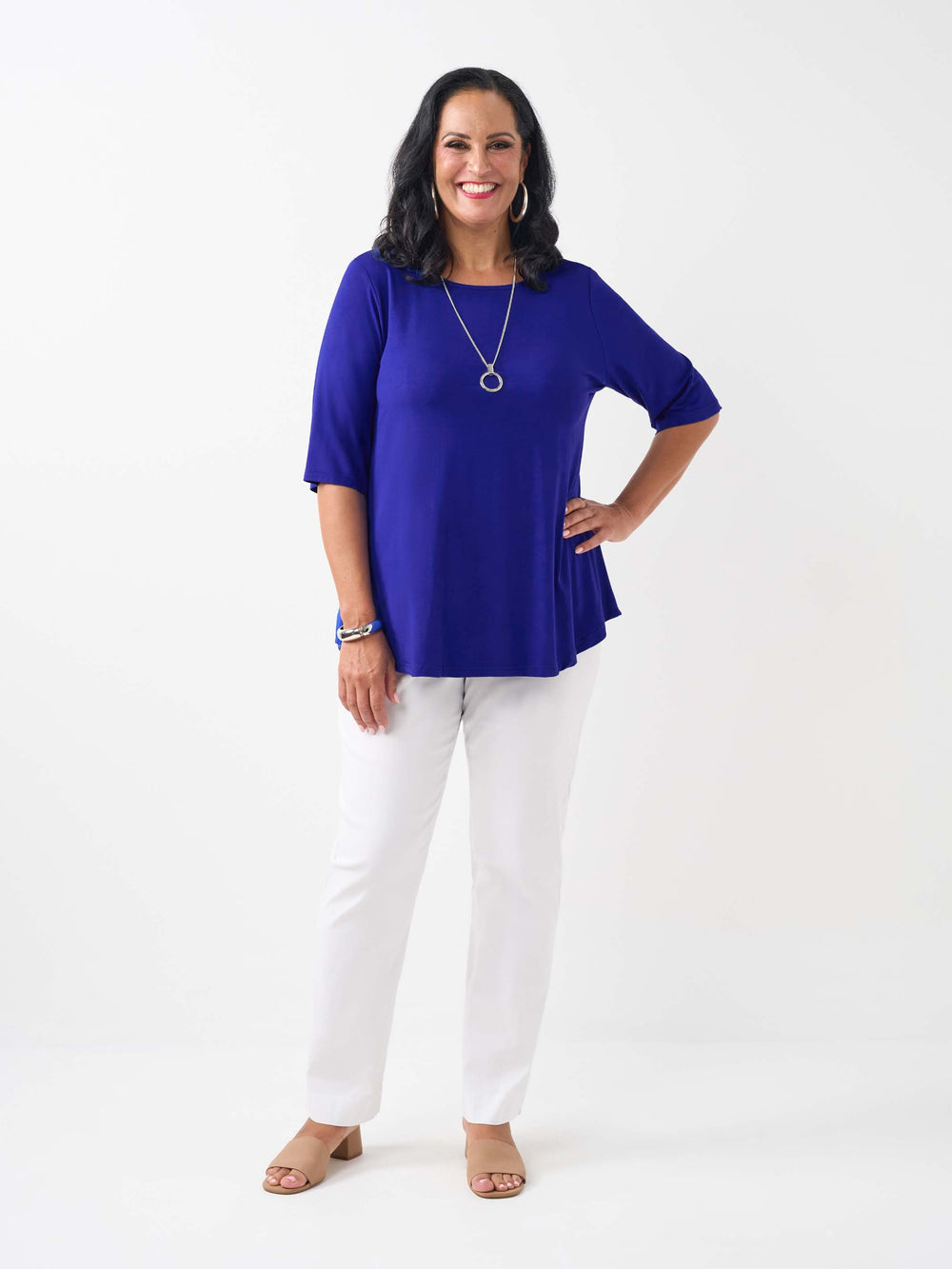 model wearing a bright ocean blue three-quarter sleeve basic T-shirt