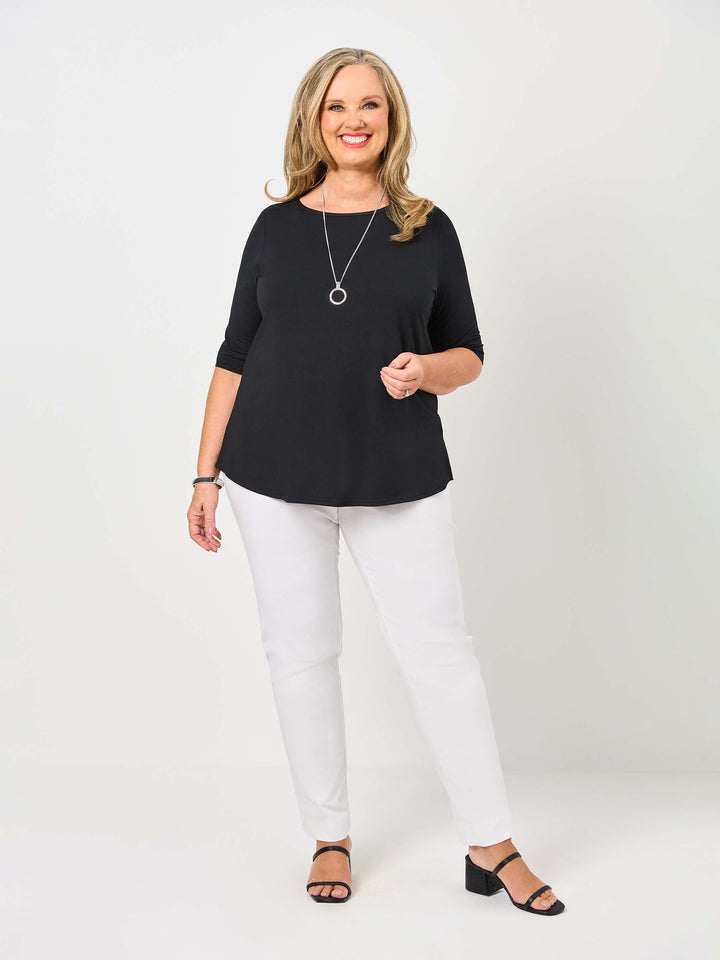 woman wearing a plain black classic tee with three-quarter sleeves paired with white pant