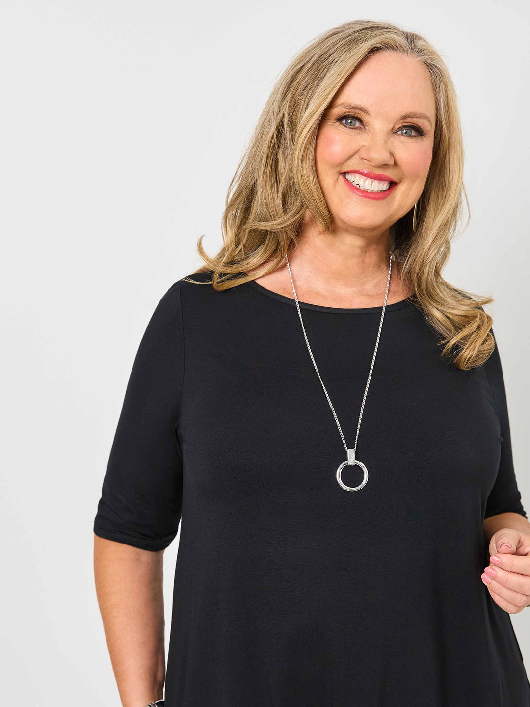 woman wearing a plain black classic tee with three-quarter sleeves