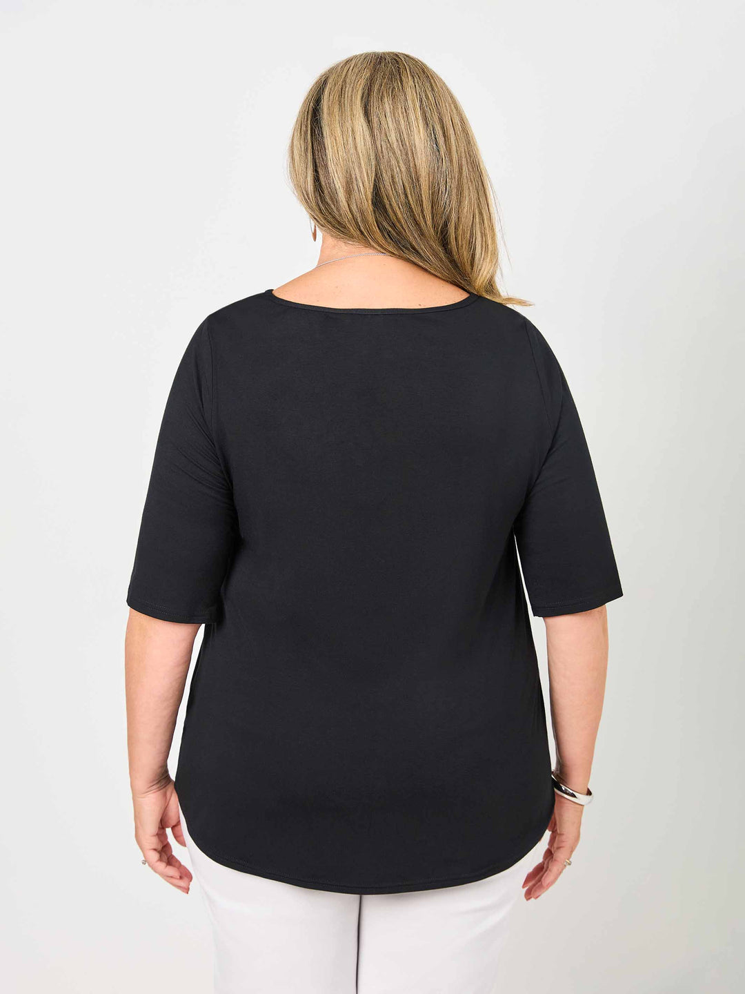 back view of woman wearing a plain black classic tee with three-quarter sleeves