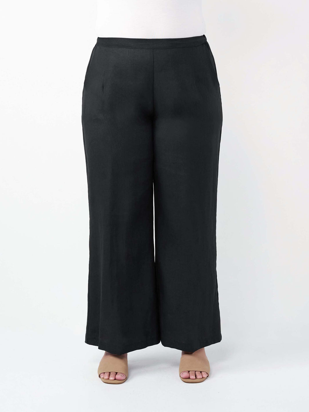 Black wide-leg linen pants shown on a model from the waist down