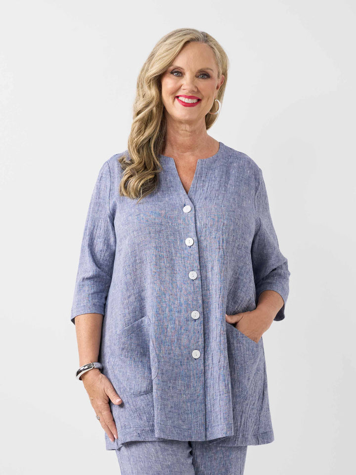 front view of model wearing a plain navy blue textured crinkle linen button-front top with matching pants