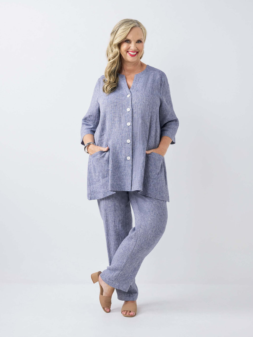 model wearing a plain navy blue textured crinkle linen button-front top with matching pants