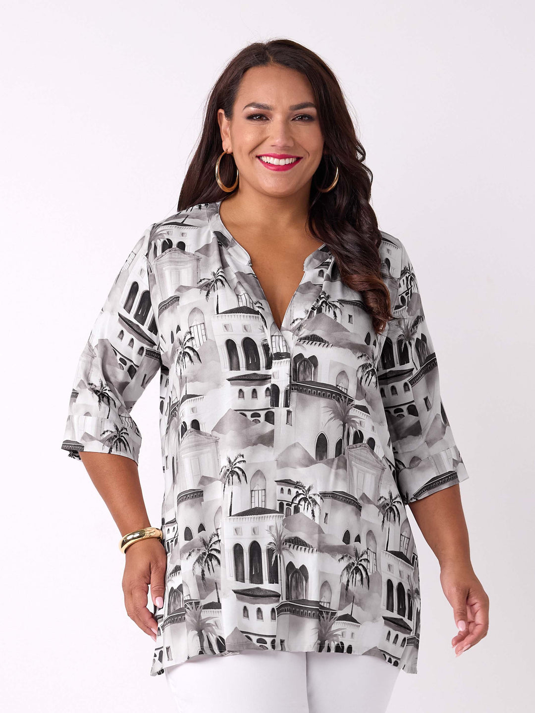 A woman wearing a nehru collared V-neck tunic top with neutral Fez inspired scenic print