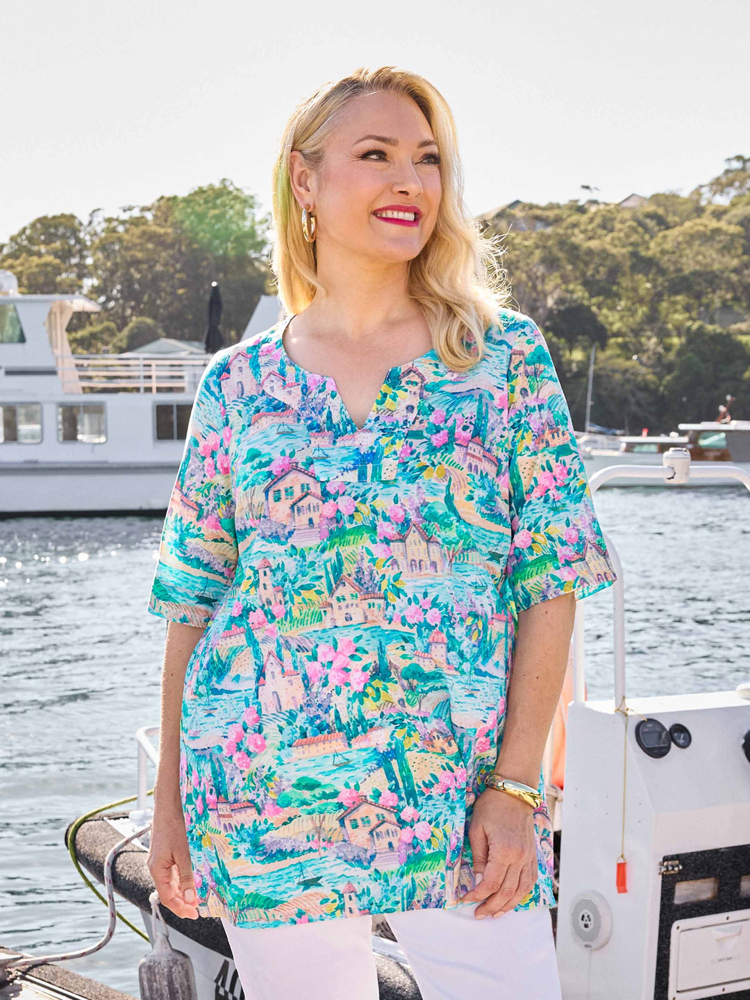 A woman wearing a colourful tropical print tunic cotton top
