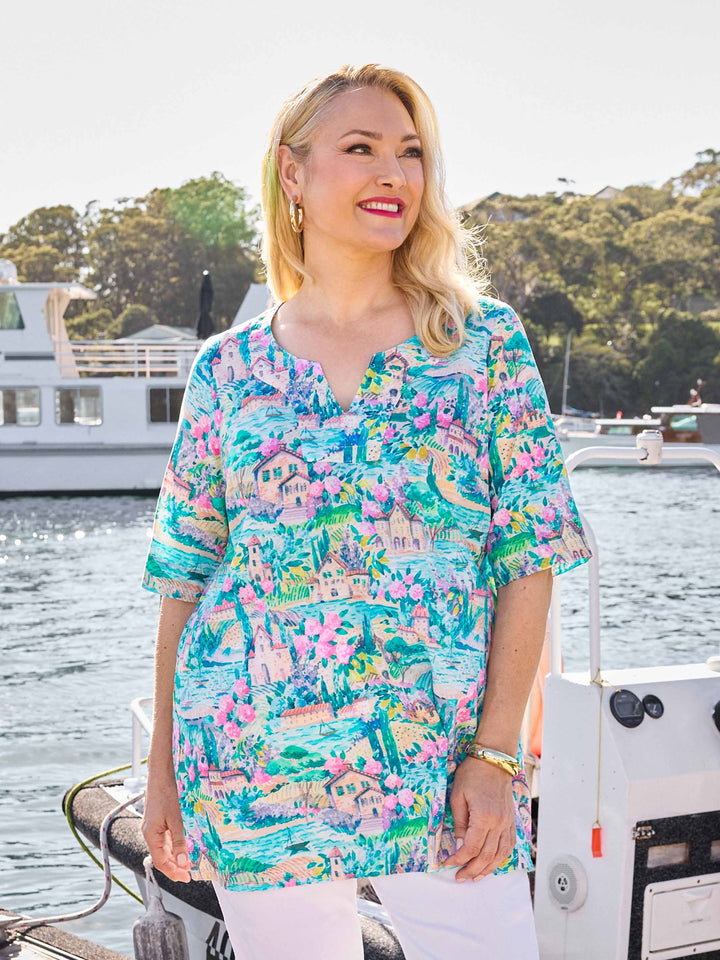 A woman wearing a colourful tropical print tunic cotton top