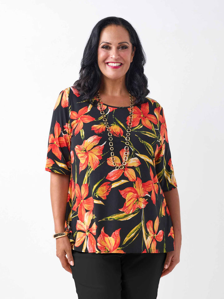 front of a black plus-size short-sleeve jersey top with a vibrant orange and red floral print