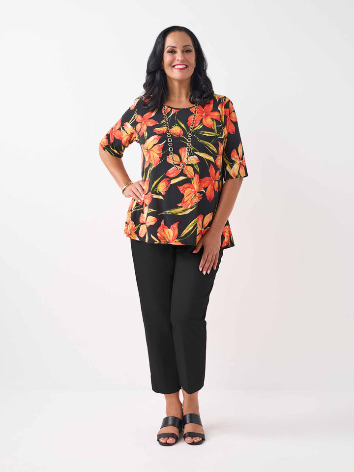model wearing a black plus-size short-sleeve jersey top with a vibrant orange  floral print, paired with black pant