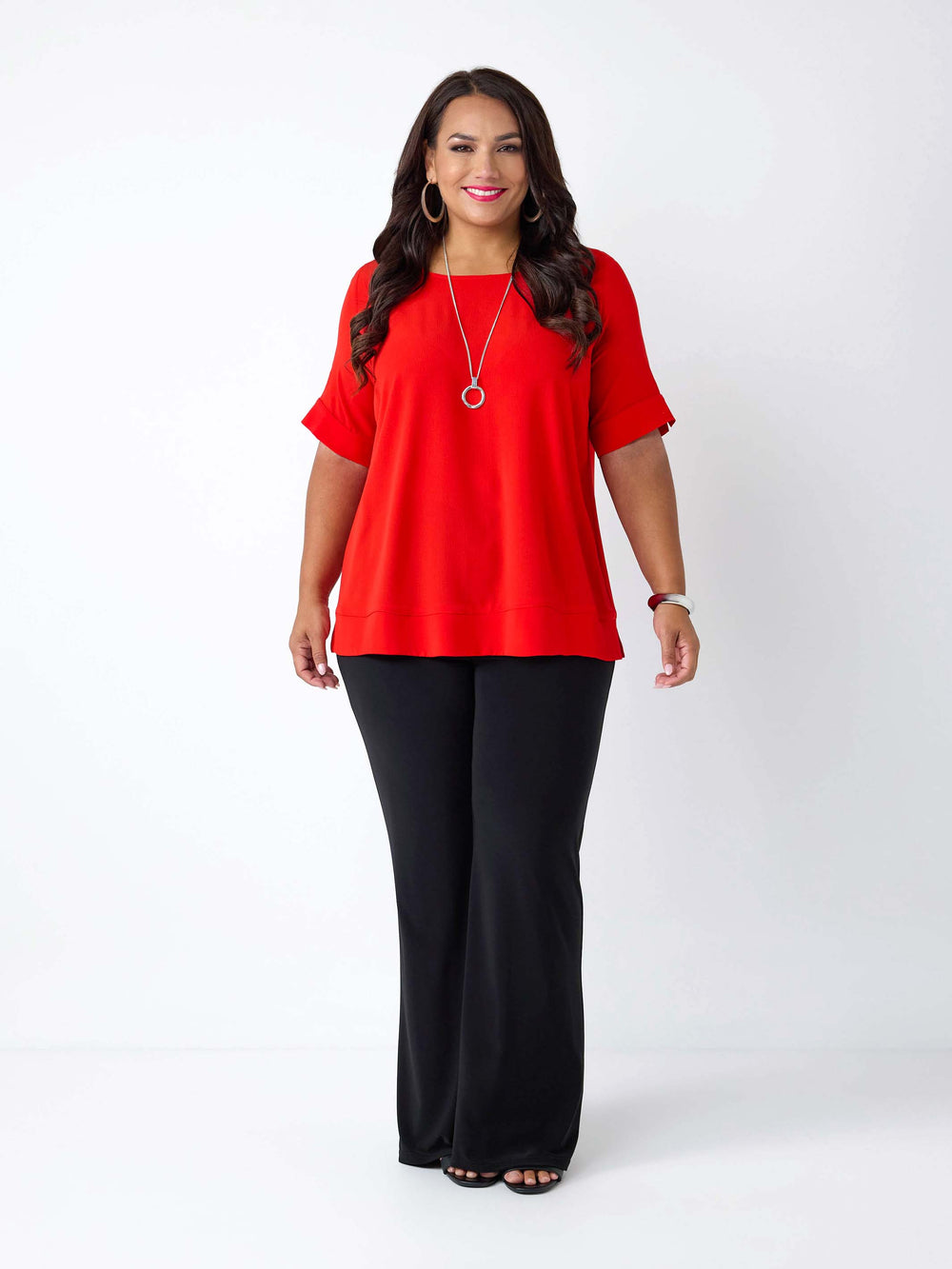 woman wearing a red round neck bubble textured top