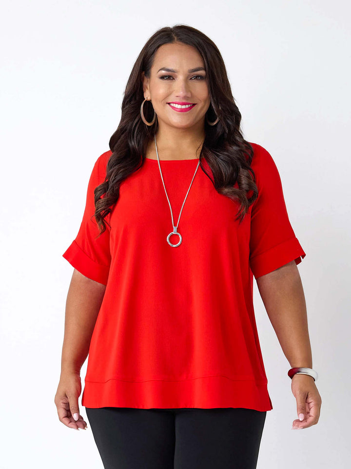 woman wearing a red round neck bubble textured top