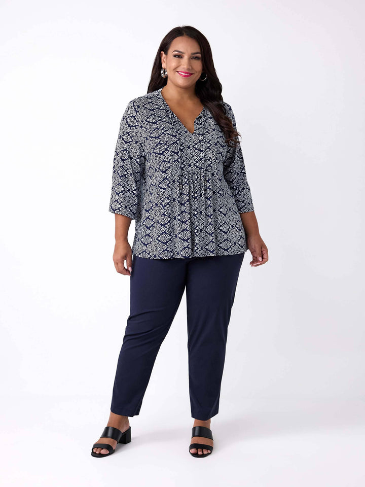 A woman wearing a three-quarter sleeve patterned top