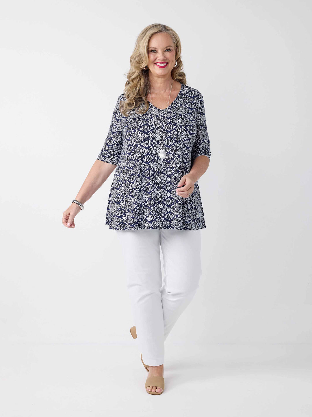 model wearing a navy v-neck swing jersey top with white print