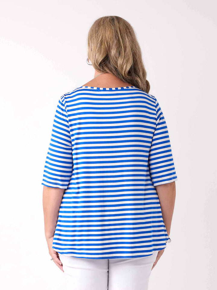 Back view of a woman wearing a cobalt blue and white striped short-sleeve top with white pants