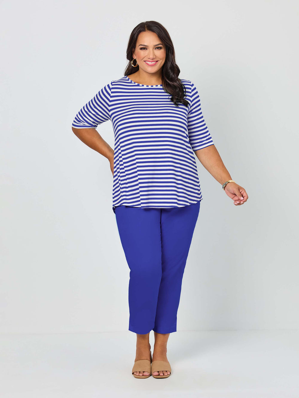 A woman wearing a short-sleeve top with light navy blue and white stripes