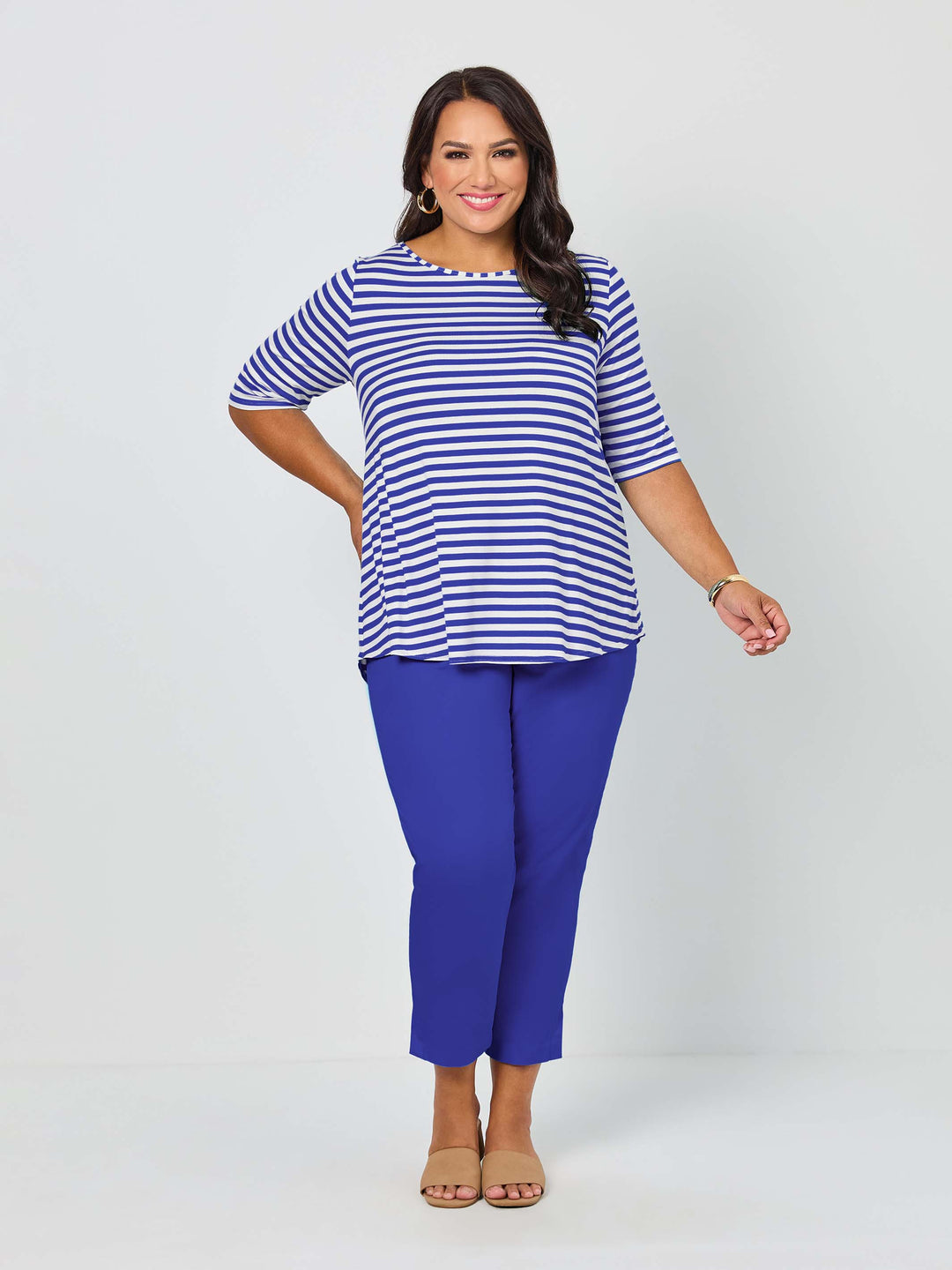 A woman wearing a short-sleeve top with light navy blue and white stripes