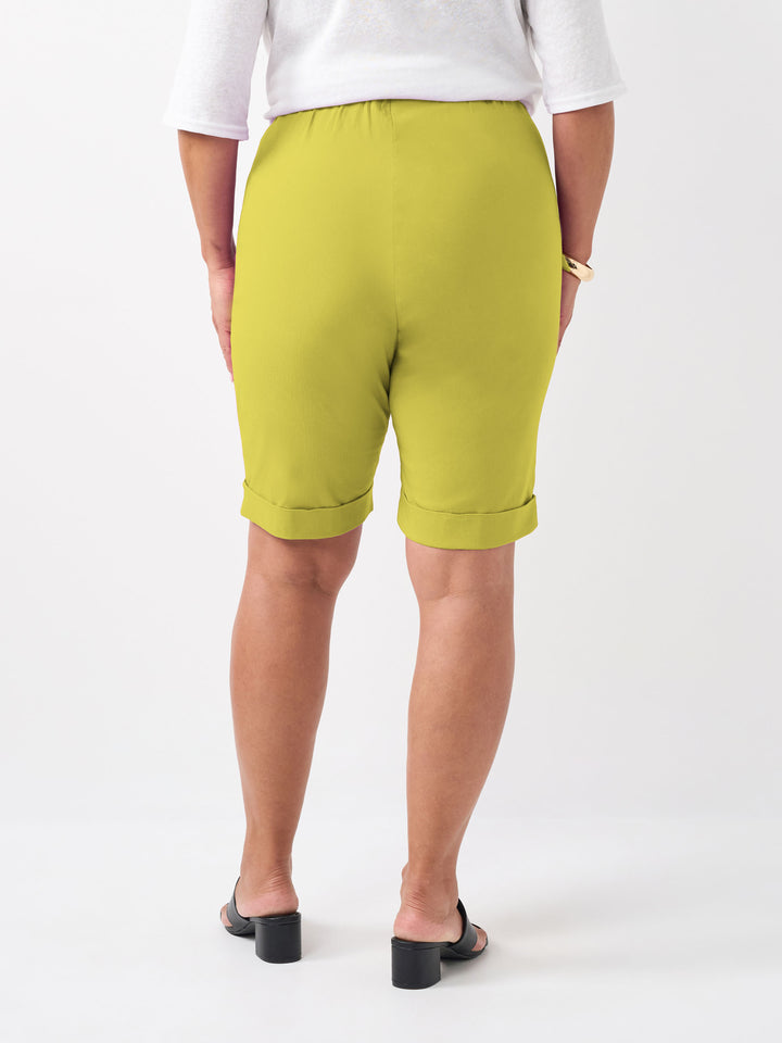 A person wearing a plain vibrant citrus knee length bengaline shorts