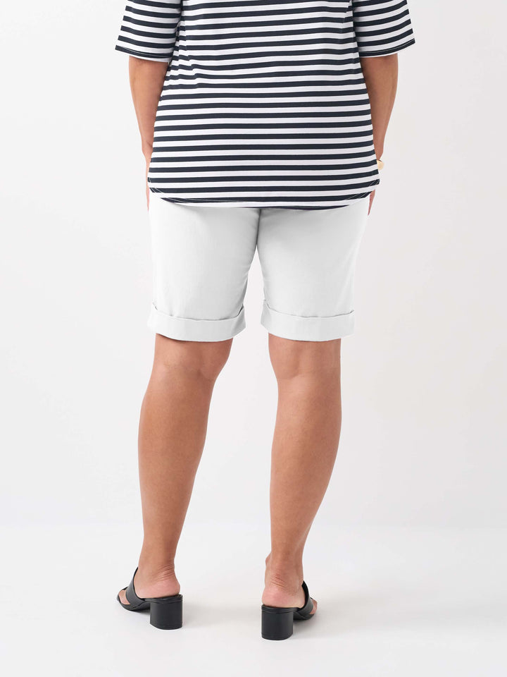 A person wearing a plain white knee length bengaline shorts