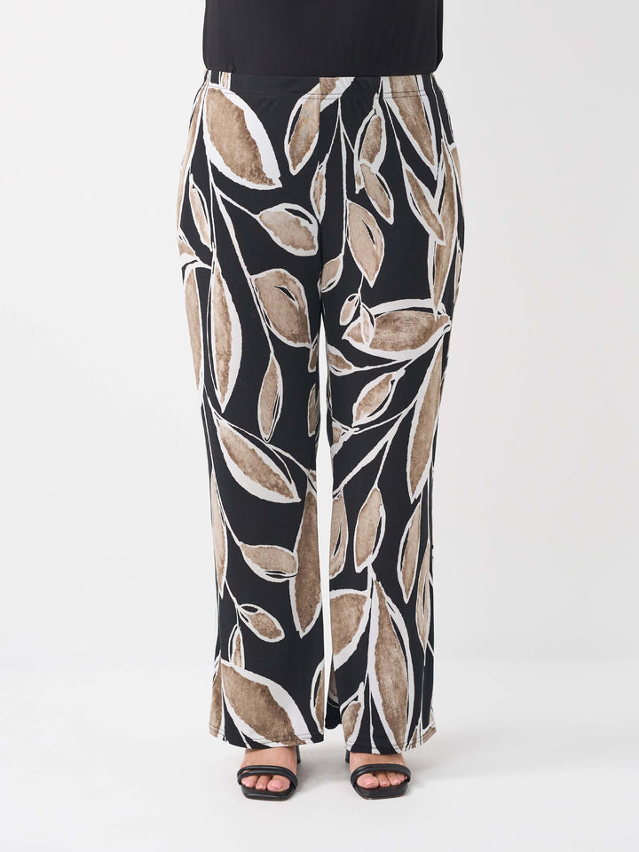 front view of a wide-leg palazzo pants with a black base and an abstract leaf pattern in beige and white