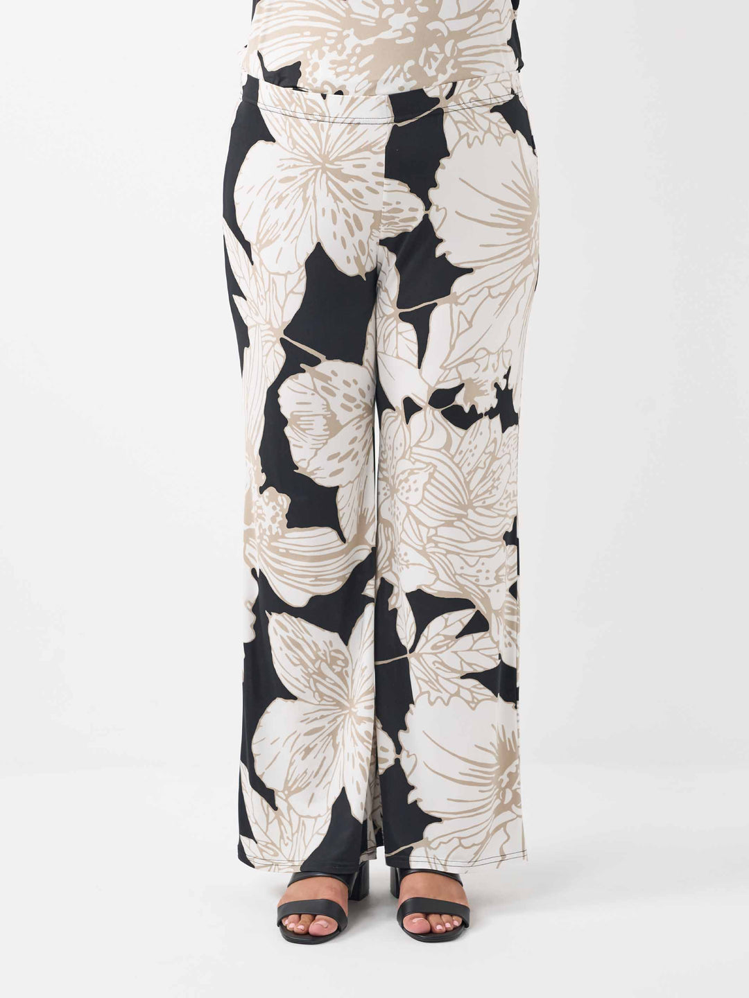 Wide-leg palazzo pants featuring a bold beige floral pattern on black base