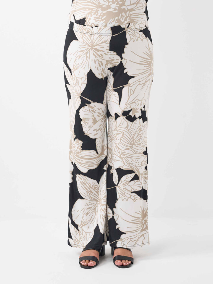 Wide-leg palazzo pants featuring a bold beige floral pattern on black base