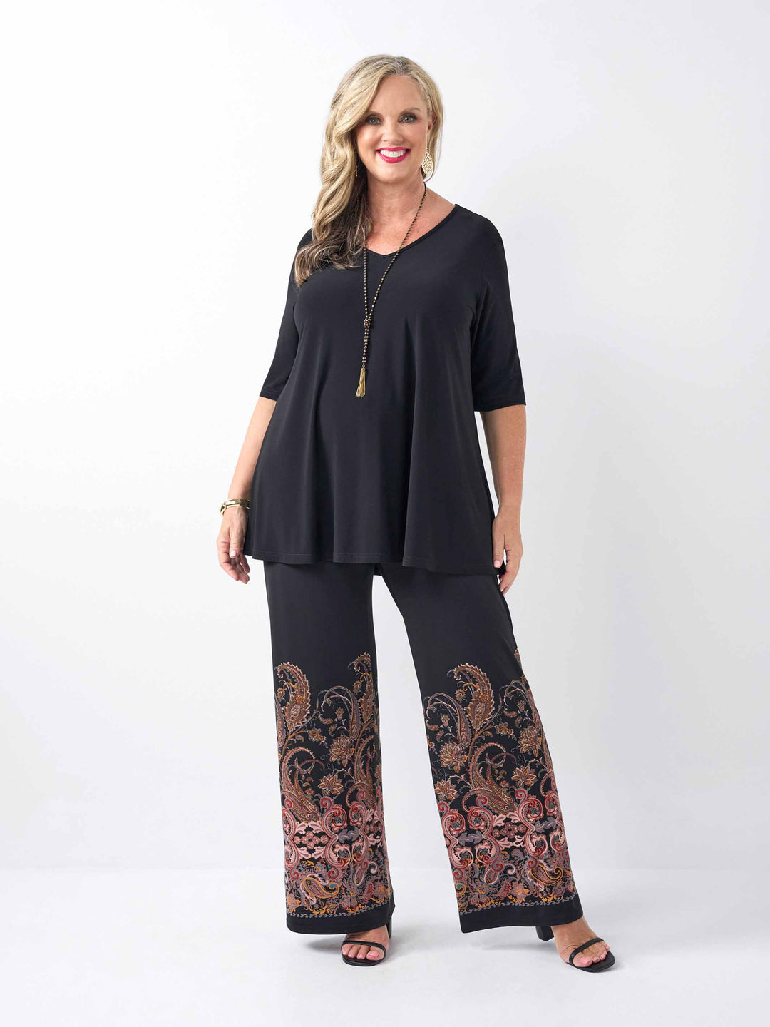a woman wearing a v-neck swing top styled with a pair of stylish palazzo pant with stylish boho inspired print