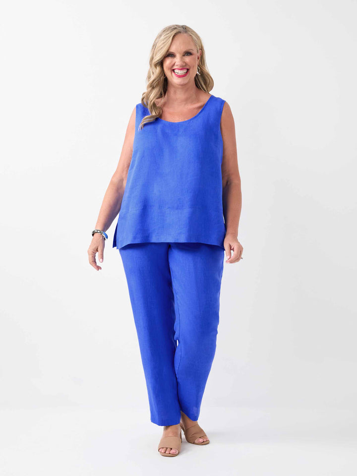 a woman wearing a bright cobalt blue linen cami, paired with matching straight leg pant in full length 