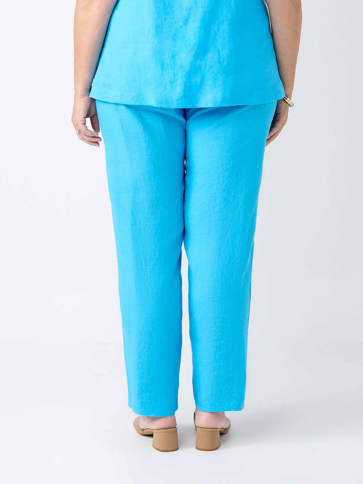 back view of a person wearing a straight leg full length linen pant in light blue