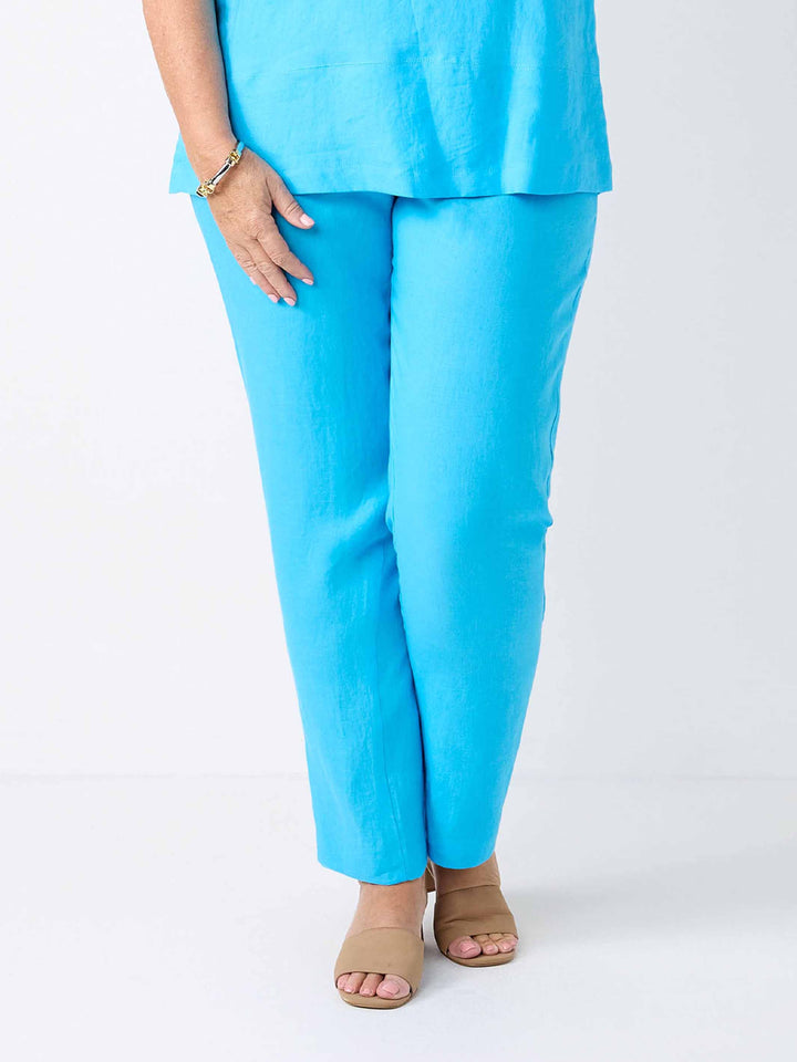 a woman wearing a plain linen straight leg pant in light oasis blue