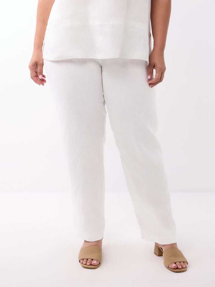 A model wearing white regular leg linen trousers
