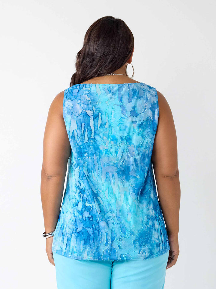 A woman viewed from the back wearing a sleeveless cami with a blue dye on burnout fabric