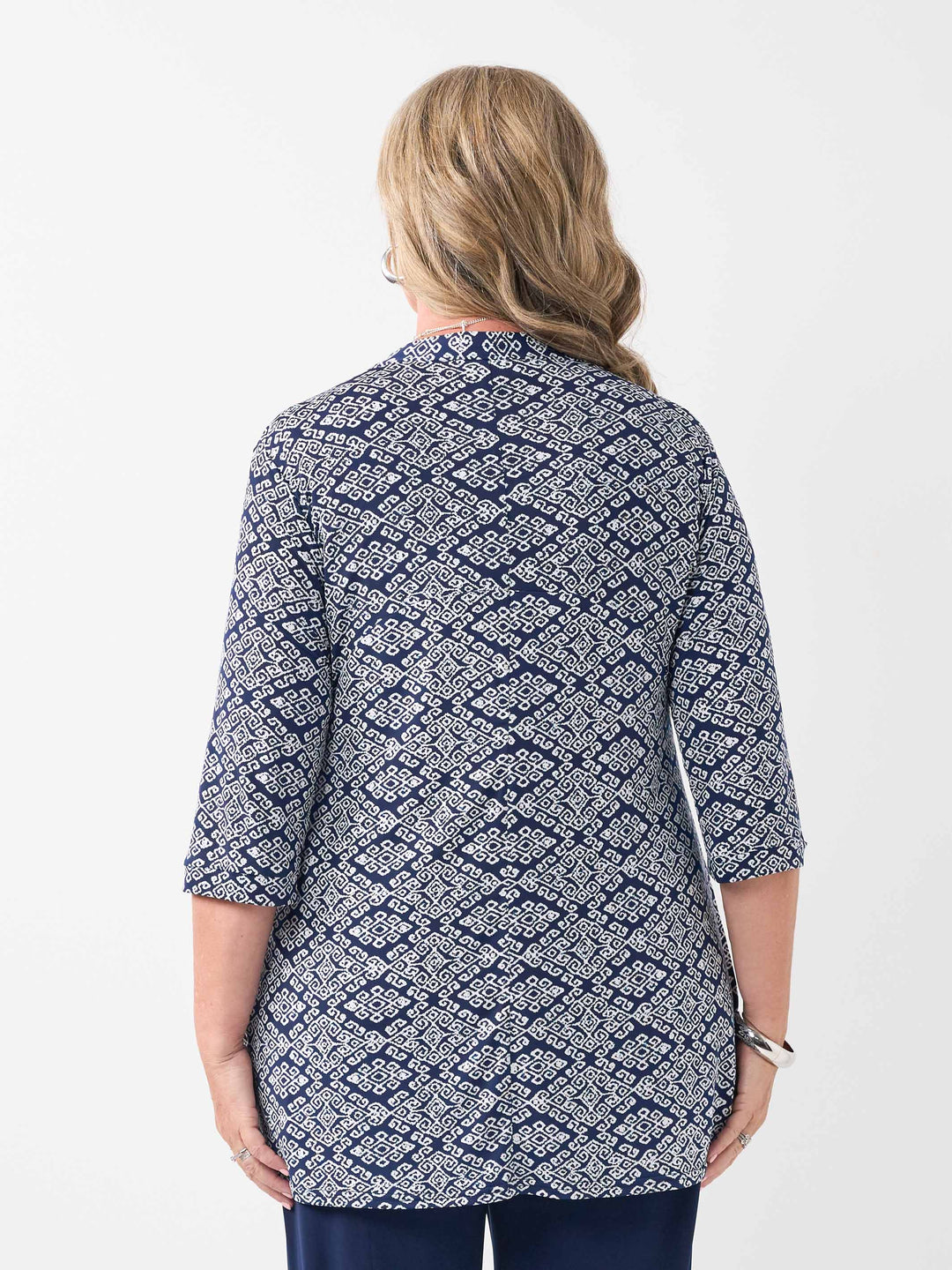 back view of woman models a navy blue and white geometric patterned lightweight jacket with three-quarter sleeves 