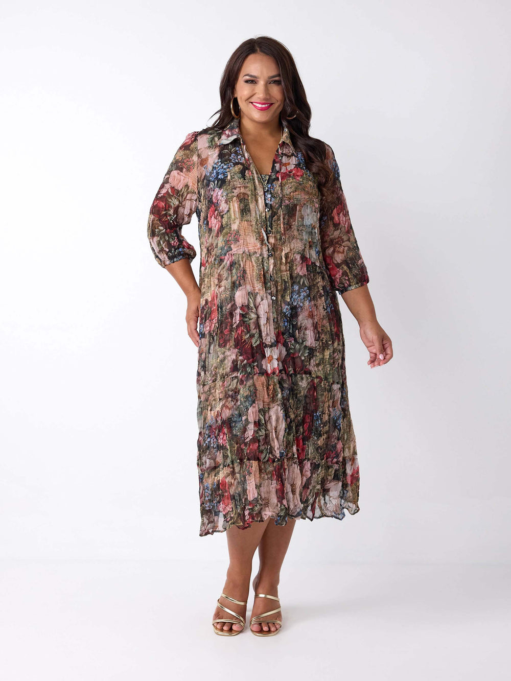 A woman wearing a v-neck collared crushed georgette midi shirt dress with garden floral print. 