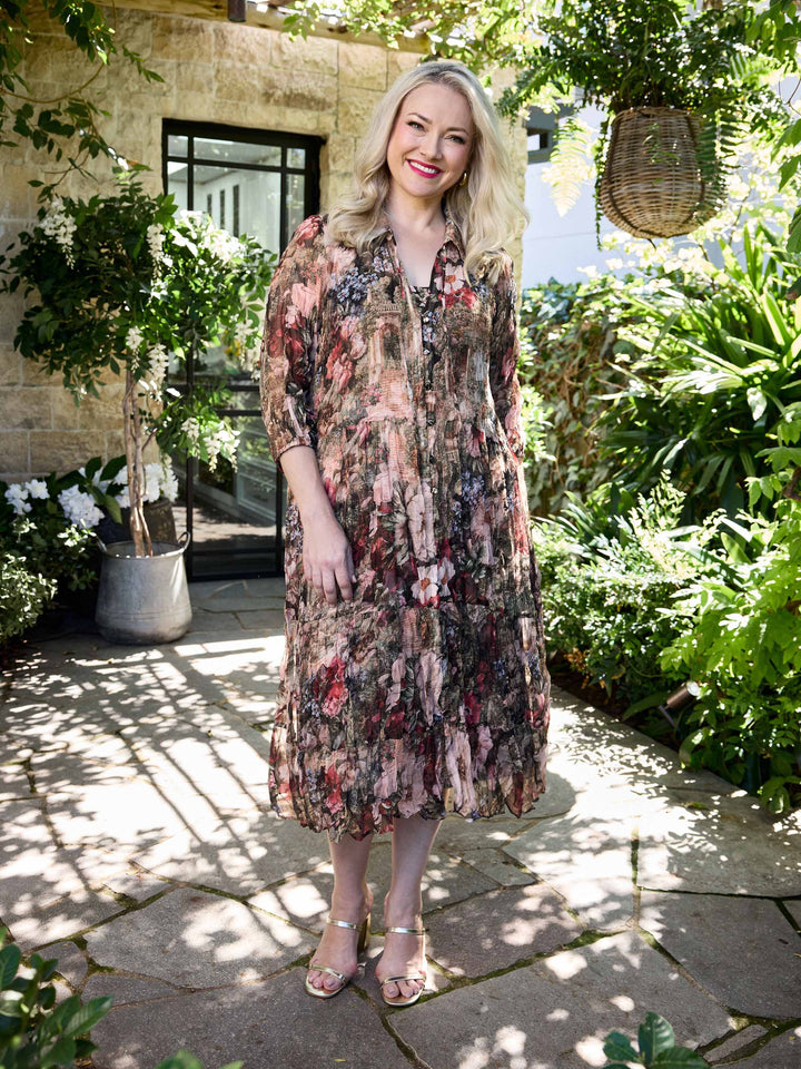 A woman wearing a v-neck collared crushed georgette midi shirt dress with garden floral print. 