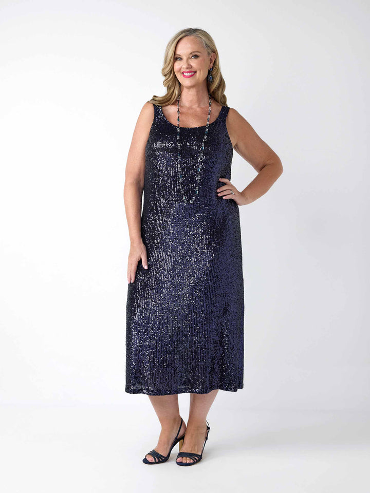 A woman wearing a sleeveless, midi-length navy blue sequined dress