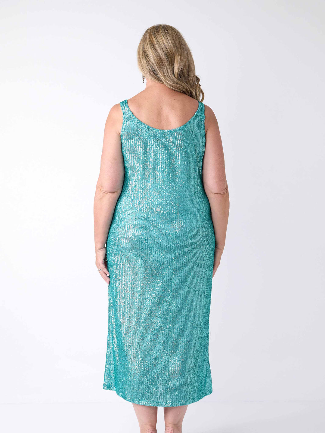 A woman wearing a sequin maxi evening dress in oasis blue