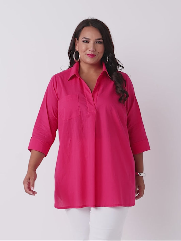 video of a model of a bright pink top with three-quarter tab sleeves