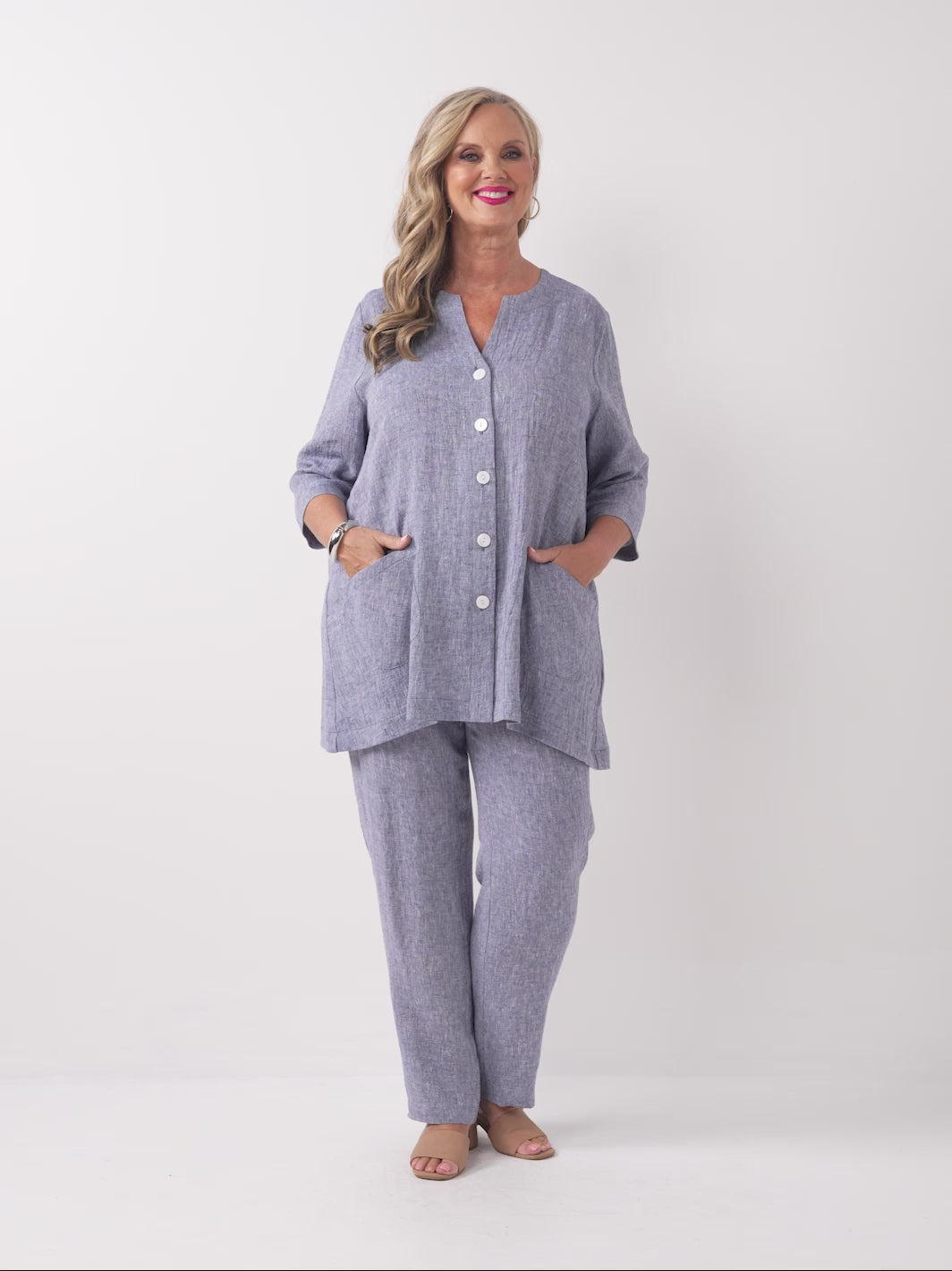 video of model wearing a plain navy blue textured crinkle linen button-front top with matching pants
