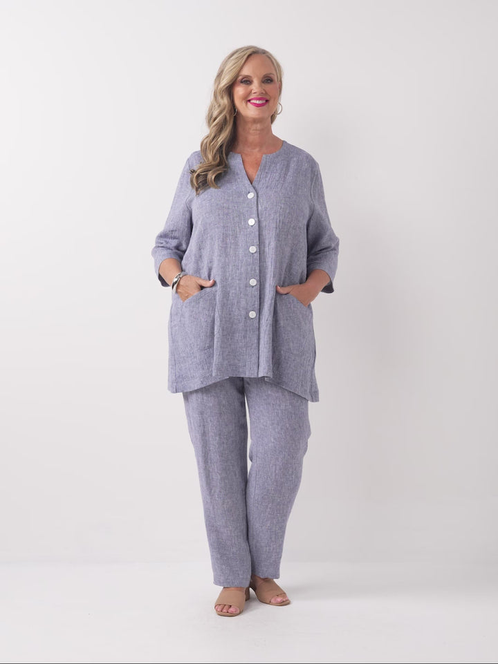 video of model wearing a plain navy blue textured crinkle linen button-front top with matching pants