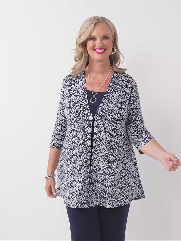 video of woman models a navy blue and white geometric patterned lightweight jacket with three-quarter sleeves 