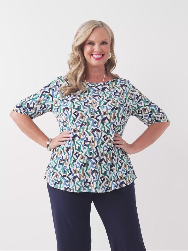 video of model wearing a three-quarter sleeve top with a colourful abstract geometric pattern