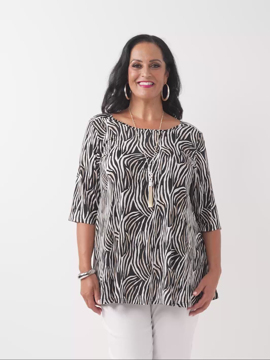 video of model wearing a black, brown and white zebra-print square neck jersey top with three-quarter sleeves