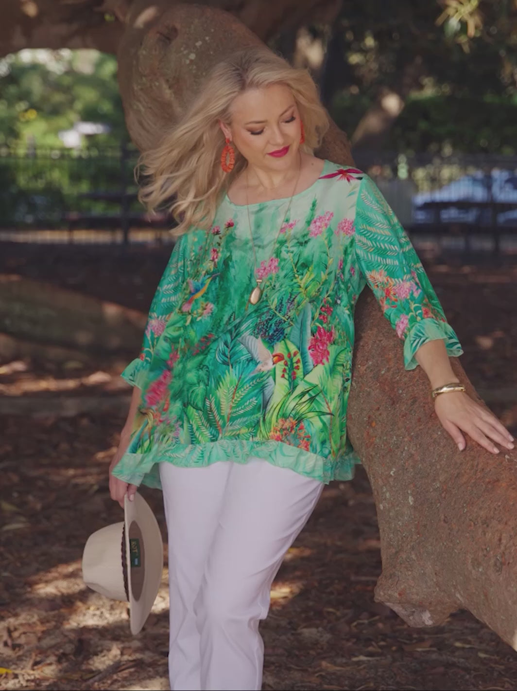 Video showing plus size Arabella print ruffle trim silky top - green on model